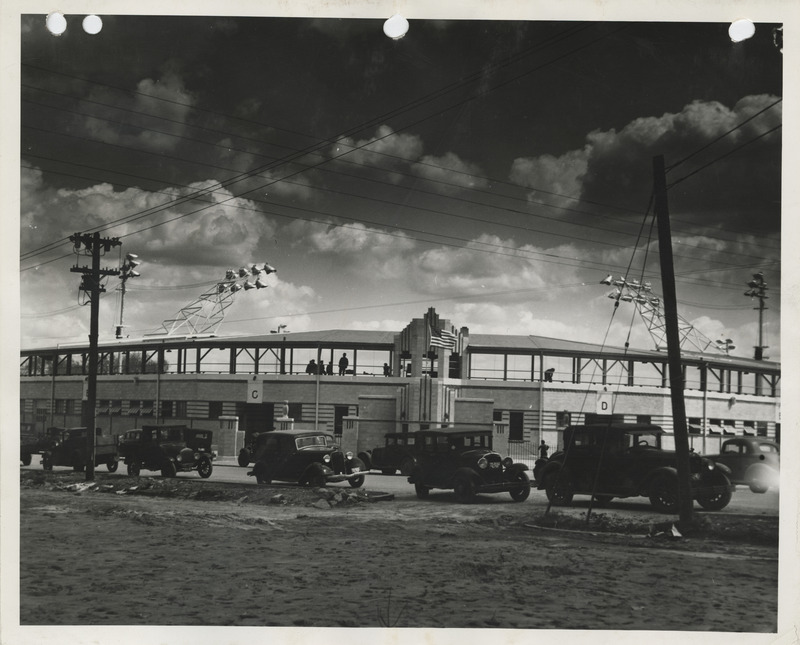 Photograph of cars parked outside the completed stadium in Clinton