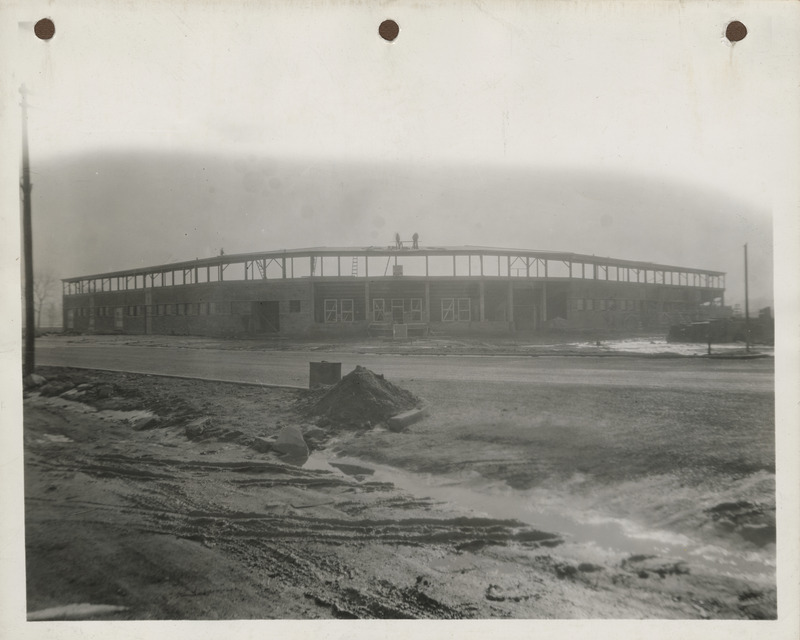 Photograph of people working atop the stands at a stadium in Clinton