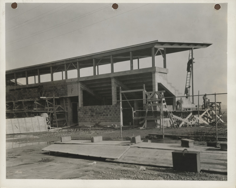 Photograph of people working on the stands at a stadium in Clinton