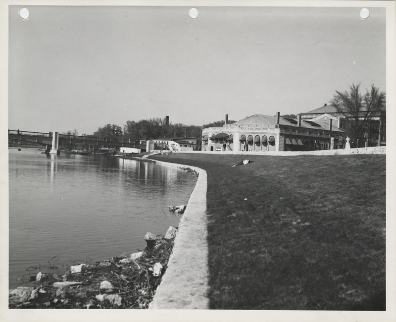 Photograph of a person lying on a levee in Iowa City