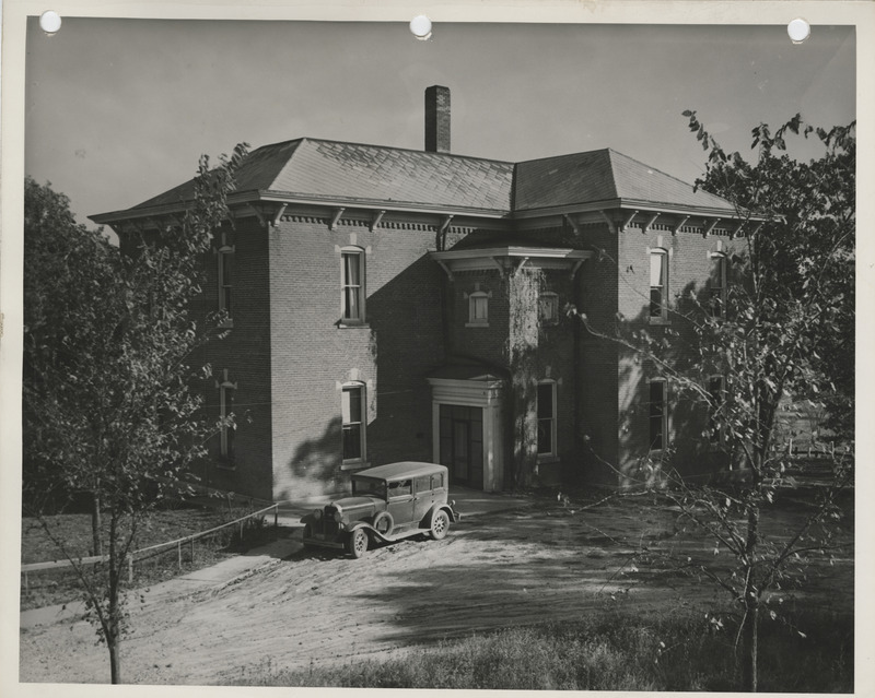 Photograph of a car parked outside the community house in Columbus Junction