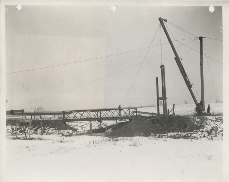 Photograph of people reconstructing a bridge in Muscatine