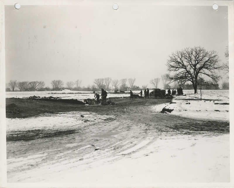 Photograph of people laying water mains at Greenwood Cemetery in Muscatine