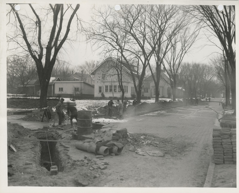 Photograph of people working on a sewer in Muscatine