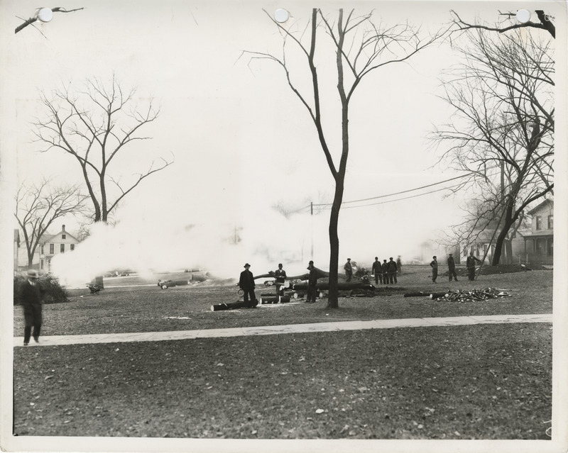 Photograph of people grading and installing lights for a softball diamond at Lafayette Square in Davenport