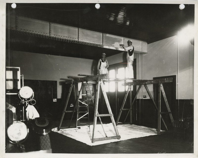 Photograph of people painting the interior of a fire station in Davenport