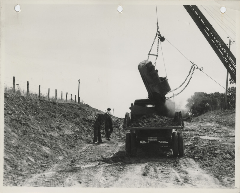Photograph of a dragline loading a truck on a farm to market road in Appanoose County