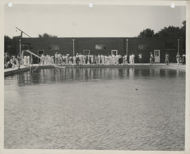 Photograph of people standing by the edge of a completed swimming pool in Adel