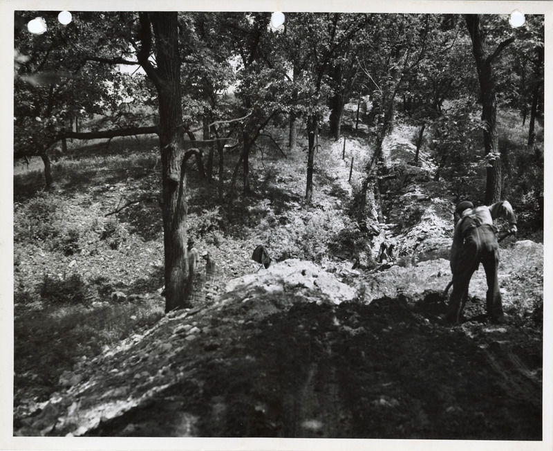 Photograph of person working on the water main in Winterset