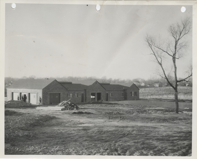 Photograph of people constructing the swimming pool and bathhouse at a city park in Pella