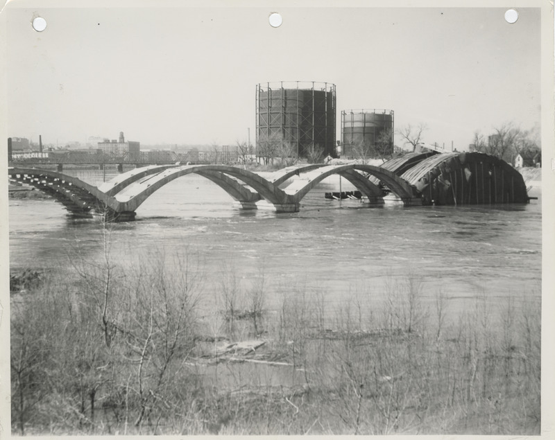 Photograph of the construction of a river bridge during flood stage in Des Moines