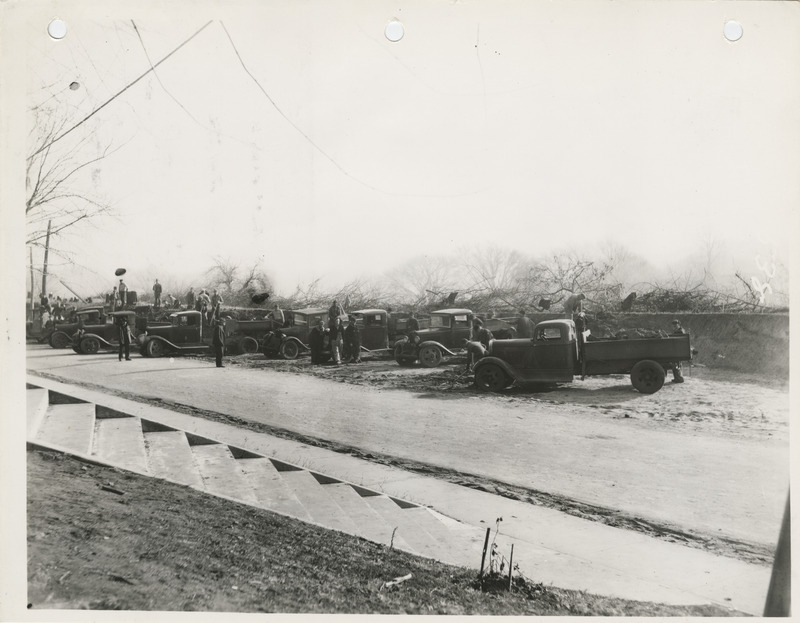 Photograph of people filling over a culvert at E 33rd and Easton in Des Moines