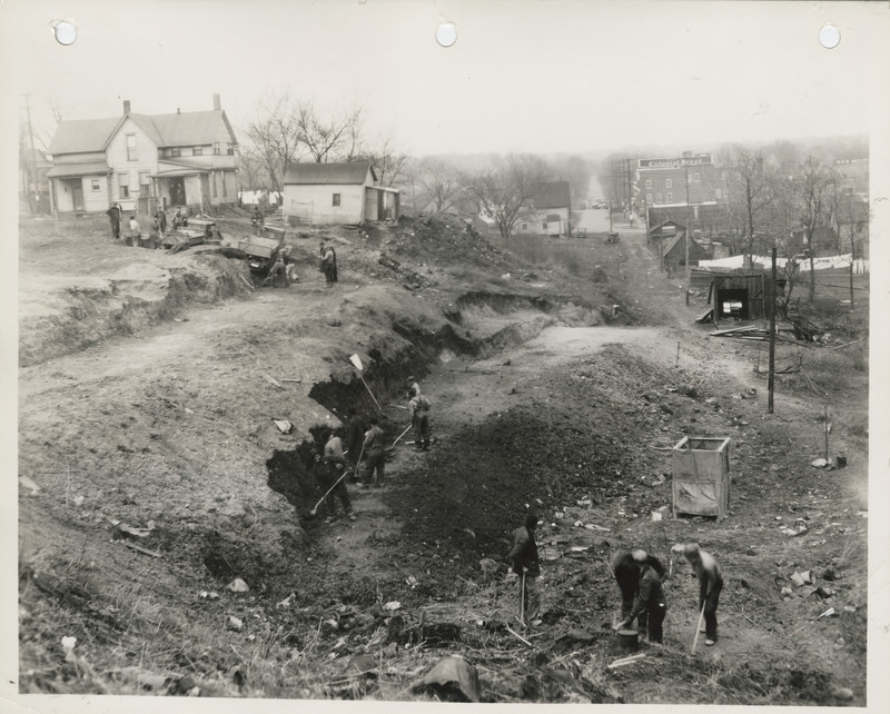 Photograph of people cutting down a hill at W 2nd and Bluff in Des Moines