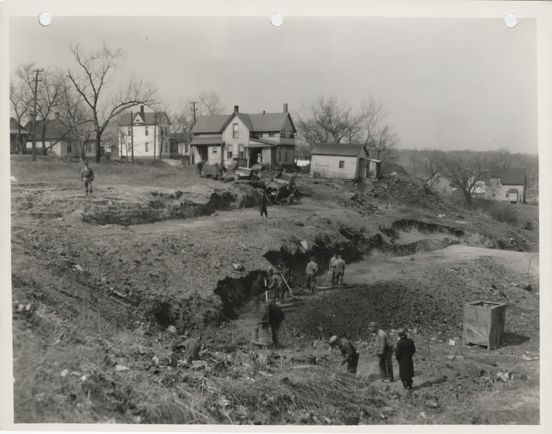 Photograph of people cutting down a hill at W 2nd and Bluff in Des Moines