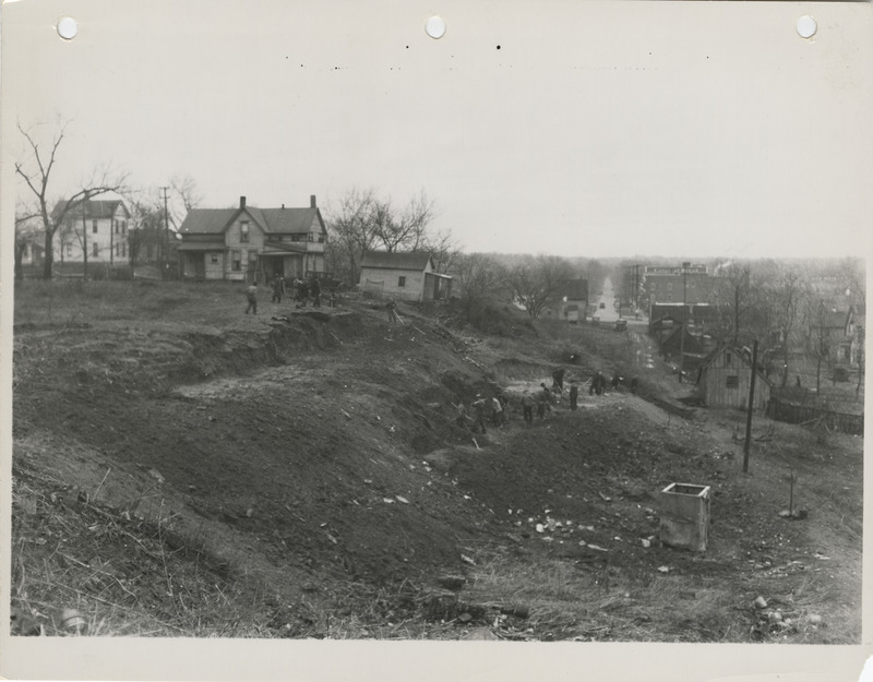 Photograph of people grading a hill at W 2nd and Bluff in Des Moines