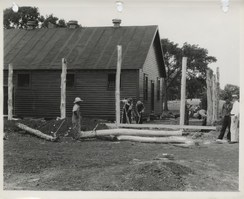 Photograph of people remodeling an old building into a clubhouse for the college golf course in Ames