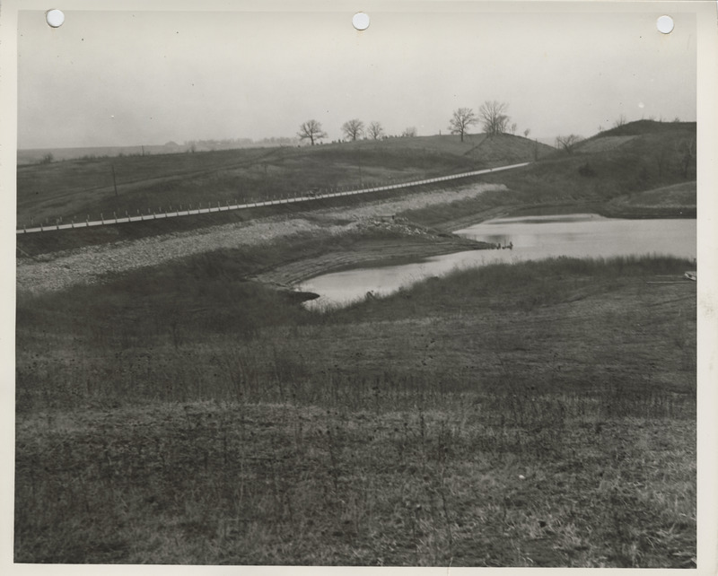 Photograph of reservoir dam and riprap along the highway in Afton