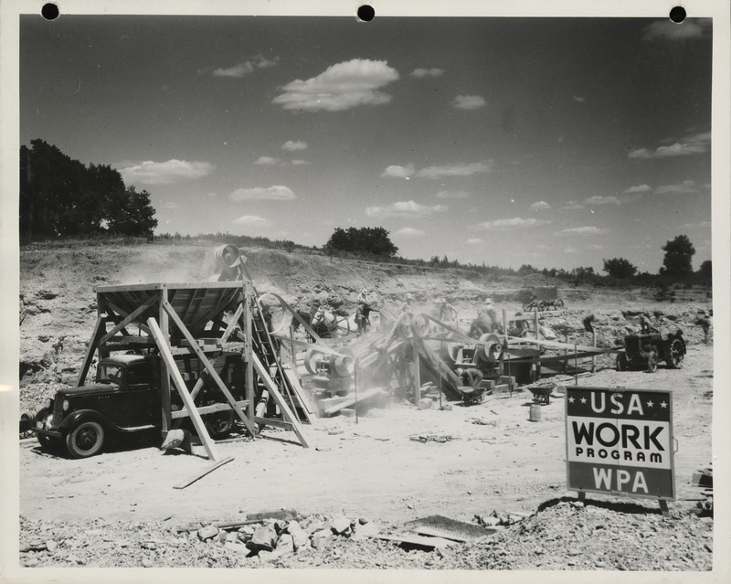Photograph of men working at the quarry using crusher in Lewis