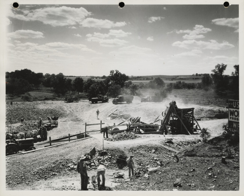 Photograph of men working at the quarry using crusher in Lewis