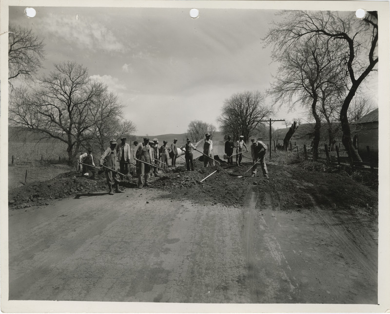 Photograph of a group of men placing a culvert at the farm-to-market road in Council Bluffs