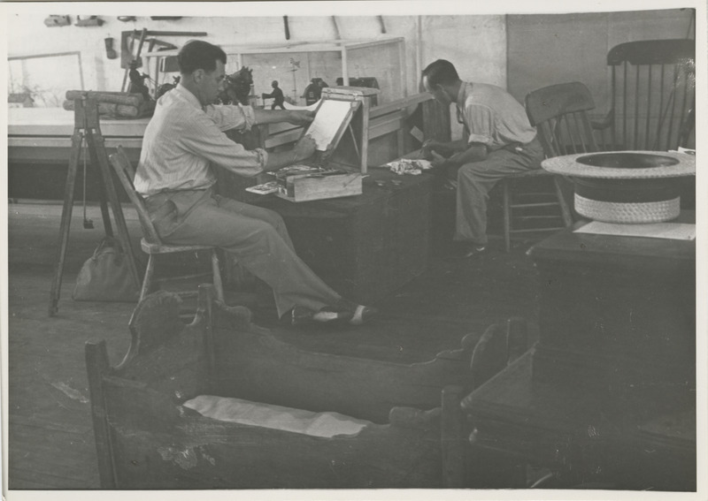 Photograph of two artists at work