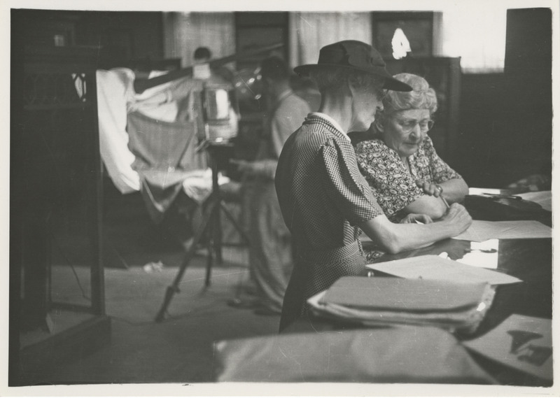 Photograph of people examining fabrics
