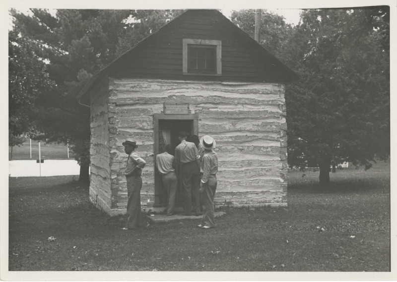 Photograph of people inspecting the Haugan house in Decorah