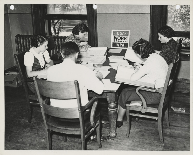 Photograph of people surveying farm records in Spencer