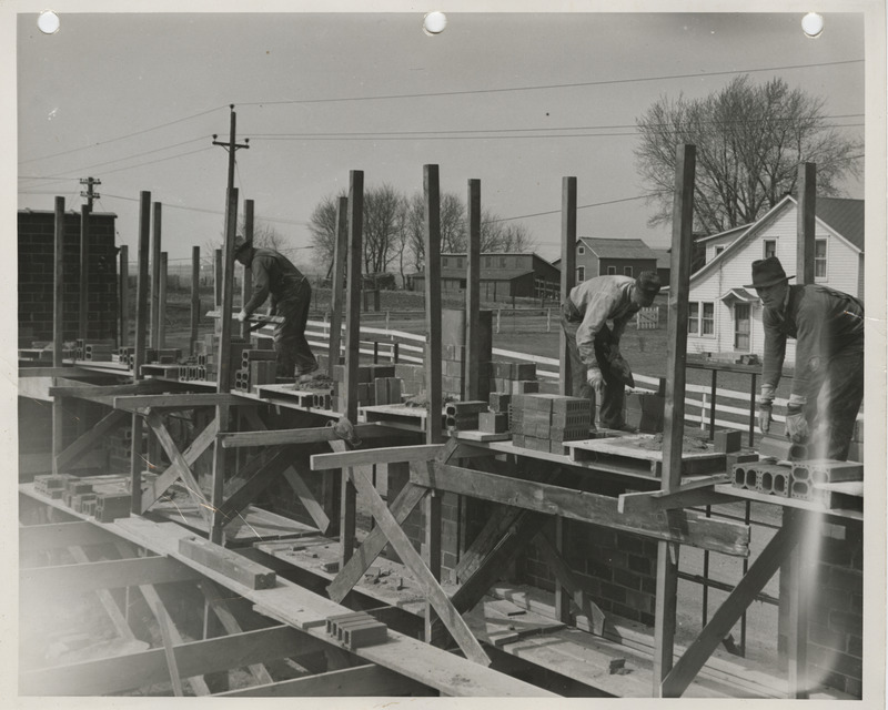 Photograph of people constructing a maintenance garage in Boone