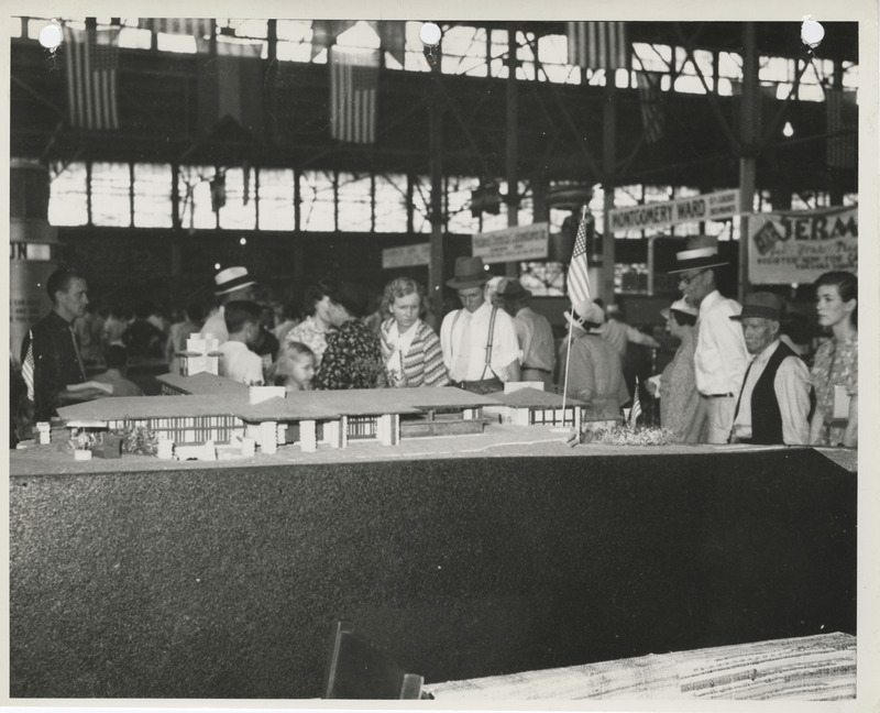 Photograph of people viewing the exhibit of the WPA project model