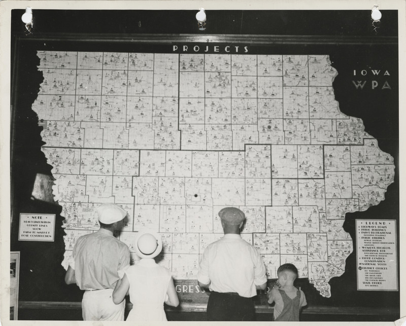 Photograph of people viewing the Iowa State map symbolizing WPA projects as to the location