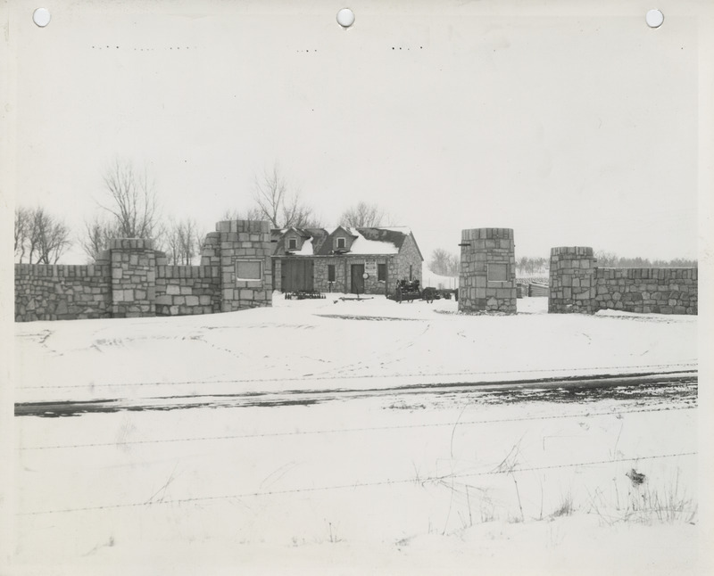Photograph of a shelter house, fence, and gates at a park in Le Mars