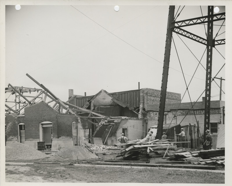 Photograph of people razing the power plant prior to reconstruction in West Liberty