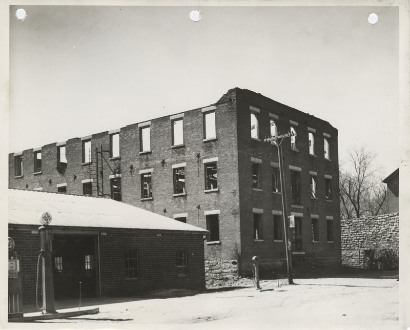 Photograph of a building to be razed at the site for a community building in Bonaparte