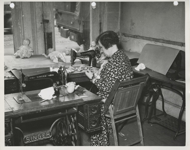 Photograph of a person making doll clothes