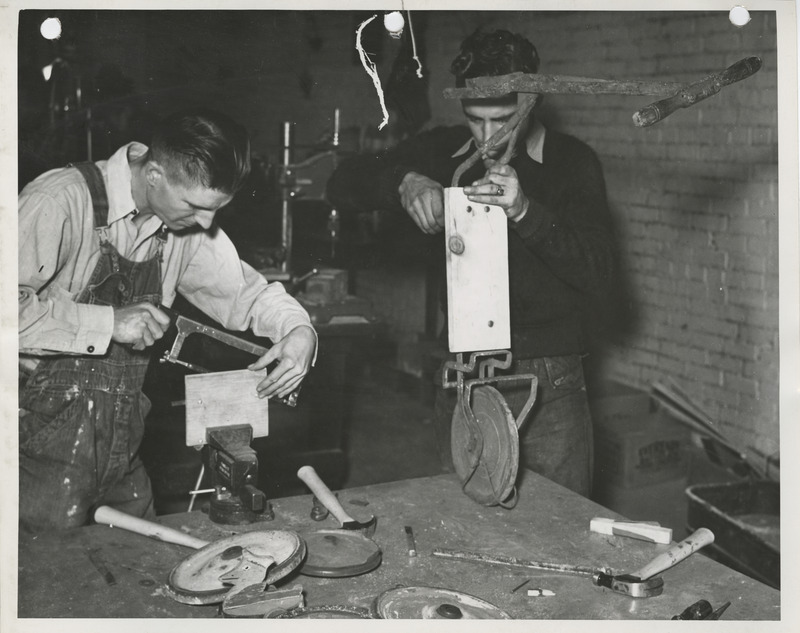 Photograph of two people woodworking