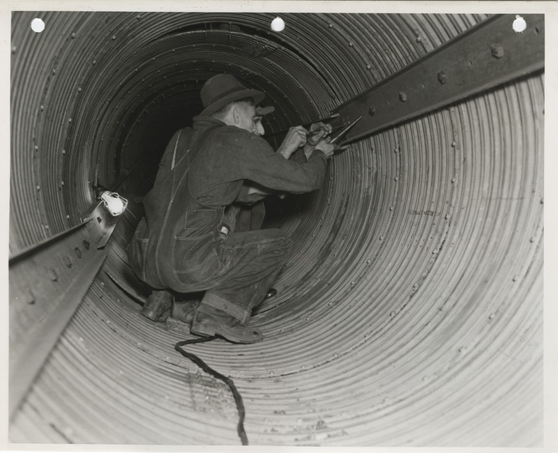 Photograph of people working on a sewer pipe in Webster City