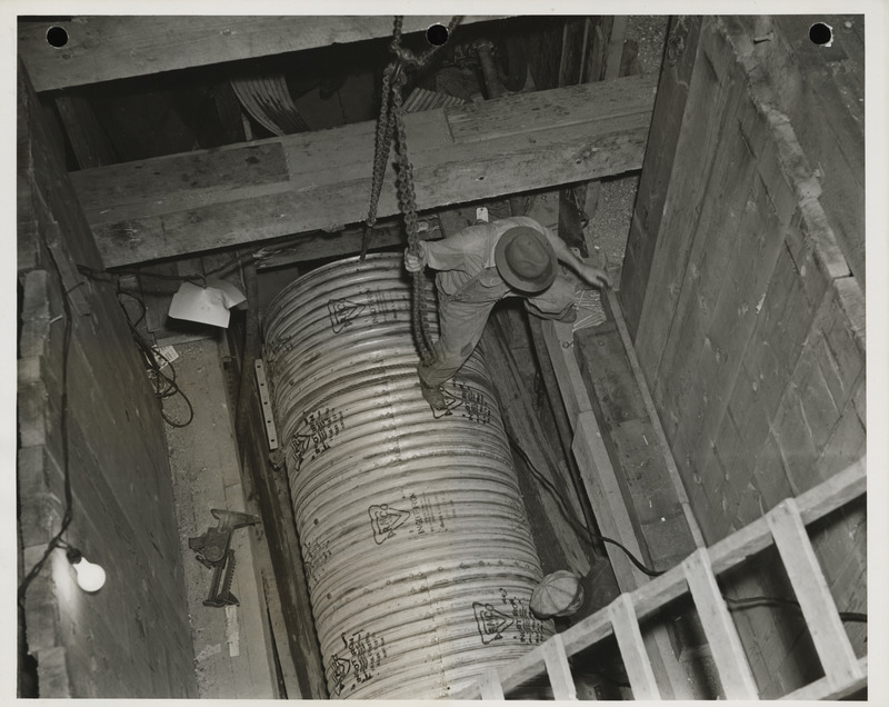 Photograph of people working on a sewer pipe in Webster City