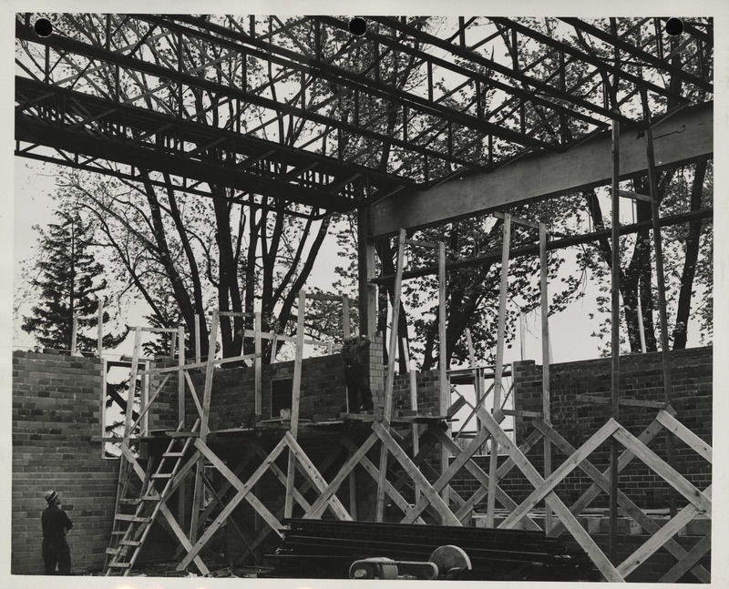 Photograph of people working on a school building gymnasium addition in Durant