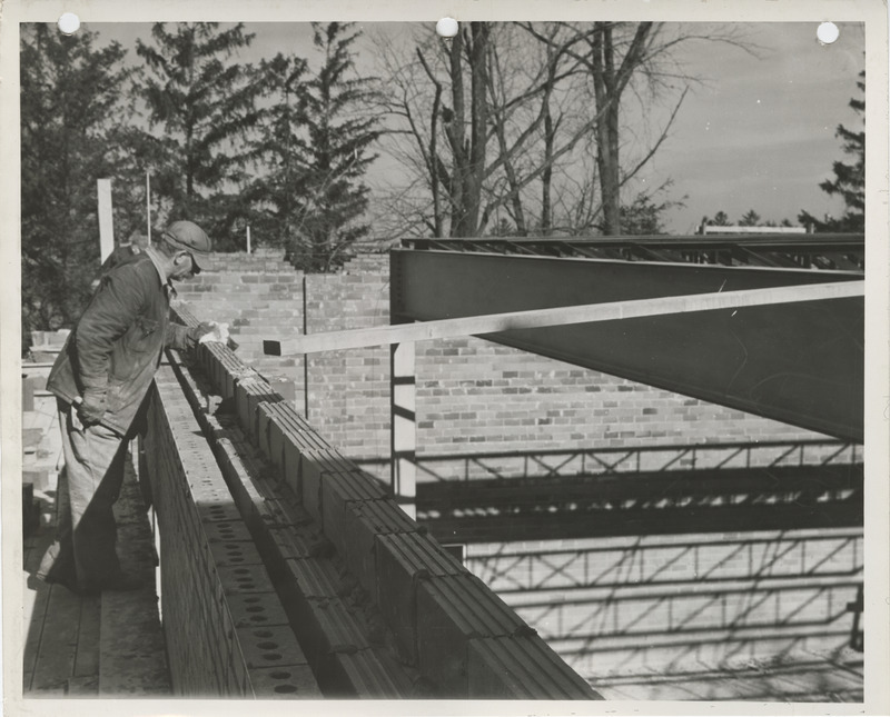 Photograph of people working on a school building gymnasium addition in Durant