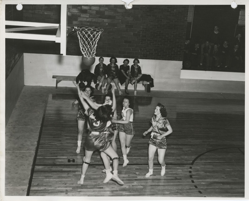 Photograph of a basketball game at a school gymnasium in Weldon