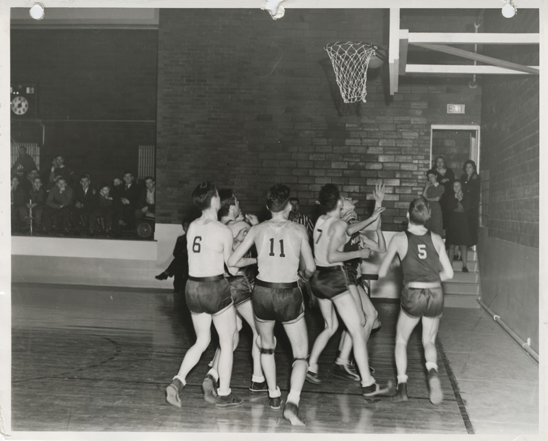 Photograph of a basketball game at a school gymnasium in Weldon