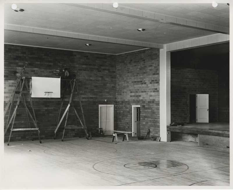 Photograph of interior construction of a school gymnasium in Little Cedar