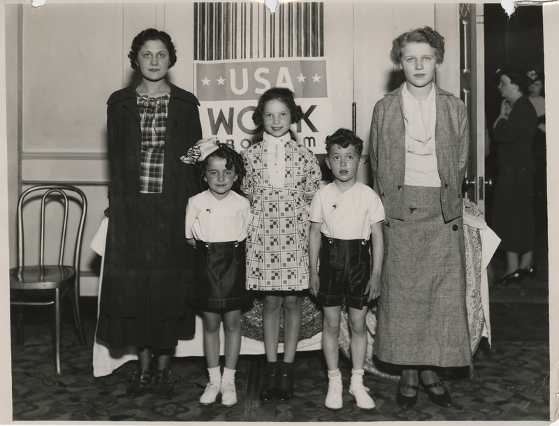 Photograph of people modeling apparel at the sewing room exhibit in Waterloo