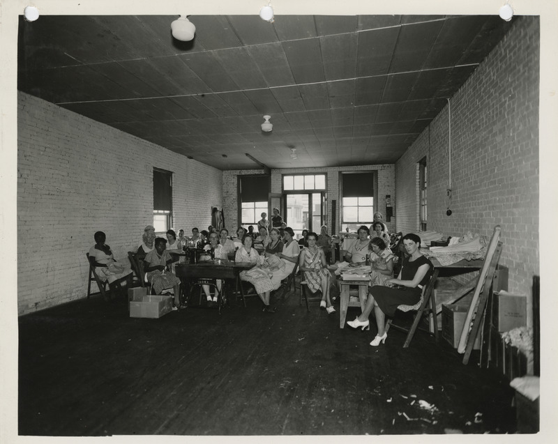 Photograph of people in a sewing room in Mason City