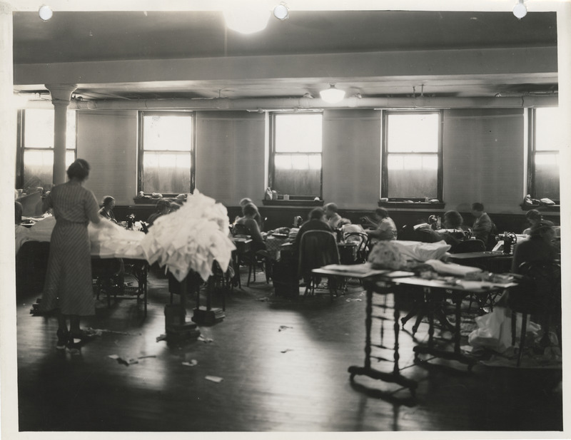 Photograph of people in a sewing room in Clinton
