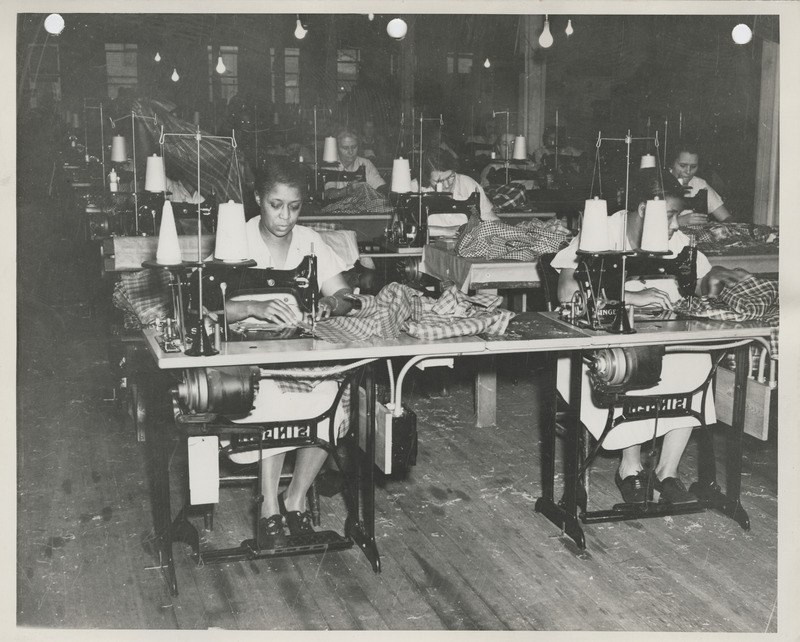 Photograph of women sewing in the sewing room in Davenport