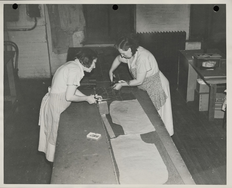 Photograph of women cutting the fabric in the sewing room in Davenport