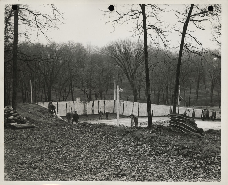 Photograph of people wrecking old swimming pool in Centerville