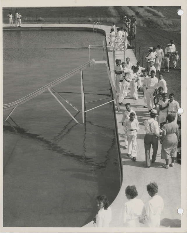 Photograph of people gathered at the municipal swimming pool in Adel